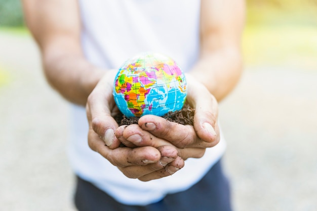 Male hands holding small globe