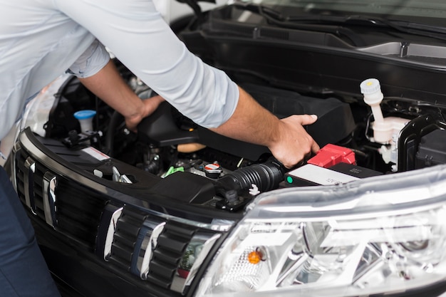 Free photo male hands taking out car engine