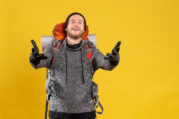 Free Photo male hitchhiker with leather gloves and backpack opening hands to hug