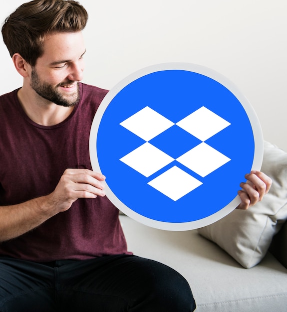 Male holding a Dropbox logo