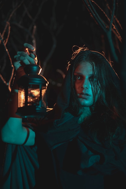 Free photo male holding a lantern in the night