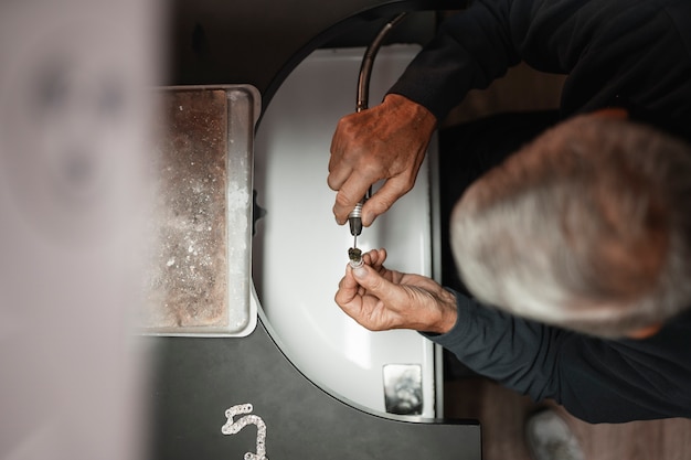 Free Photo male jeweler working in the shop