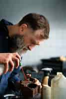 Free photo male mechanic working in auto repair shop on car