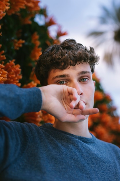 Free photo male model posing with hands near face