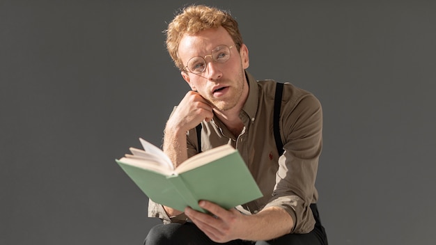 Male model with curly hair reading