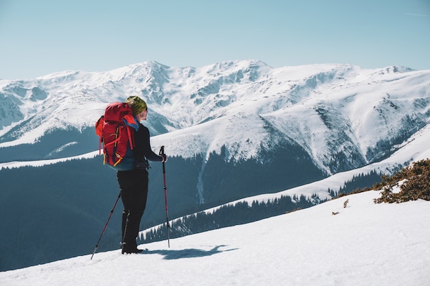 Male mountain climber enjoying  the snow covered mountain view from the summit