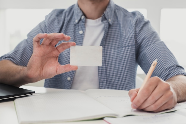 Free photo male at office holding business card