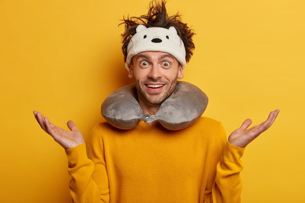 Free photo male passenger wearing inflated travel pillow over neck and cute eye mask