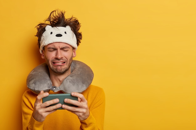 Free Photo male passenger wearing inflated travel pillow over neck and cute eye mask