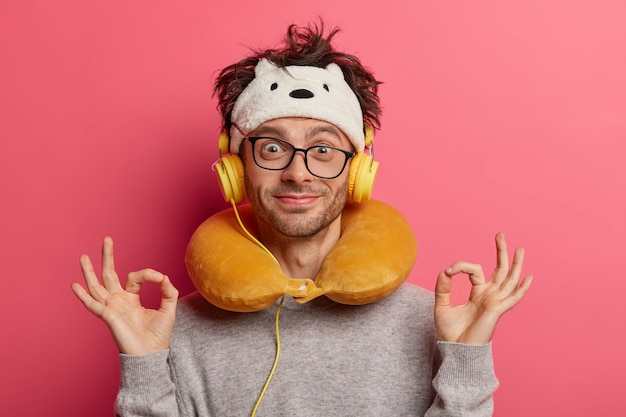 Free Photo male passenger wearing inflated travel pillow over neck and cute eye mask