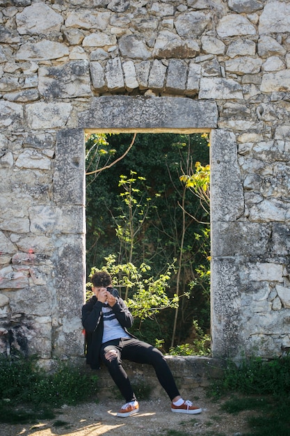 Free photo male photographer taking picture of nature