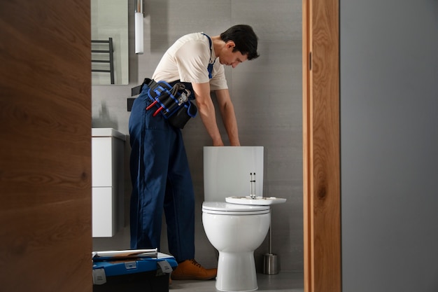 Free Photo male plumber working to fix problems at client's house