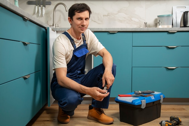 Free photo male plumber working to fix problems at client's house