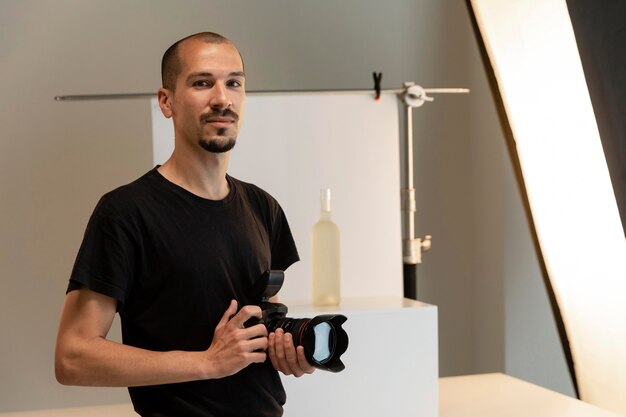 Male product photographer doing his job in the studio