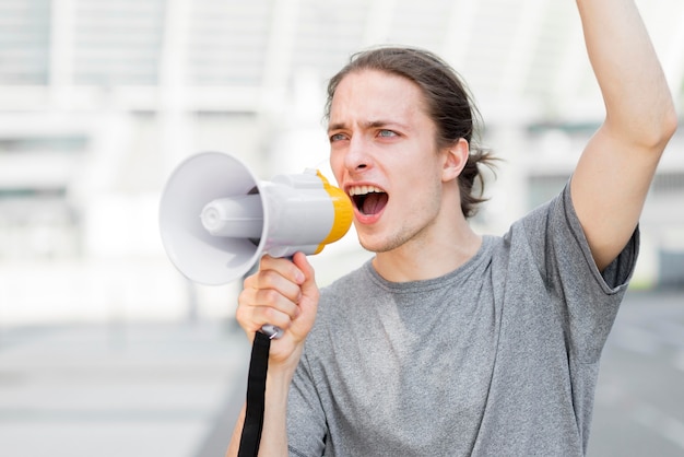 Male protester screaming in megaphone