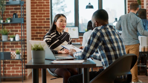 Free photo male recruiter interviewing job seeker about work experience, making employment offer. man and woman meeting to discuss about hr recruitment, analyzing resume information to hire.