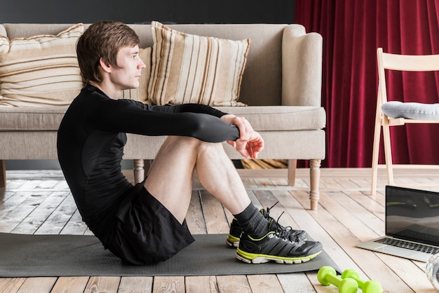 Free photo male resting sitting on mat