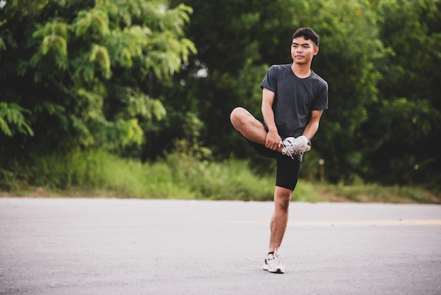 Male runner doing stretching exercise, preparing for workout