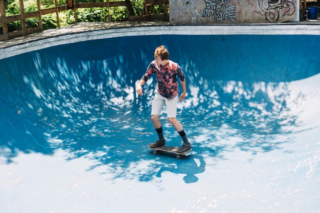 Male skateboarder riding on ramp