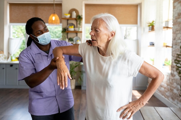 Male social worker taking care of an old woman