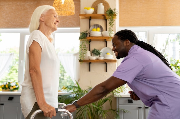 Male social worker taking care of an old woman