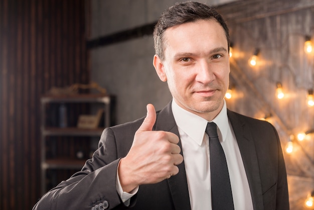 Free Photo male in suit showing thumb up 