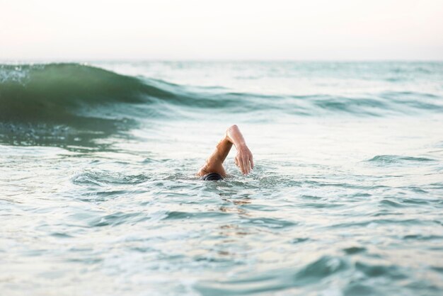 Male swimmer swimming in the ocean