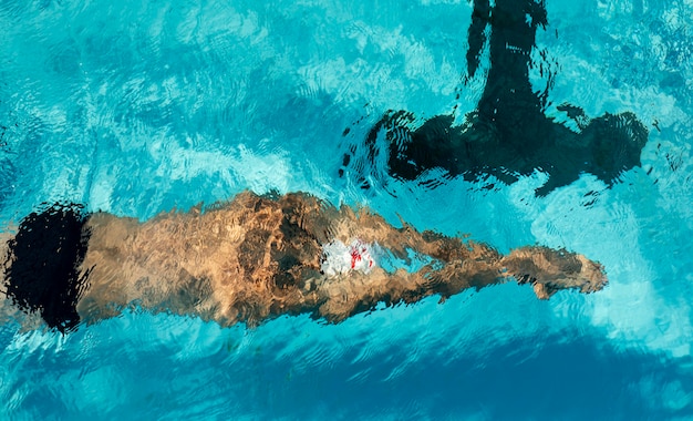 Male swimmer swimming in water pool