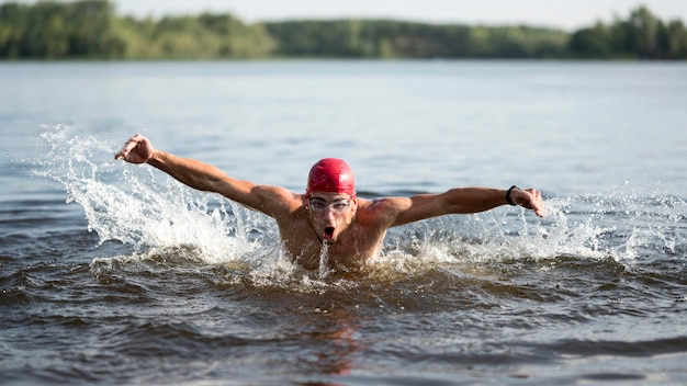 Male swimming in lake