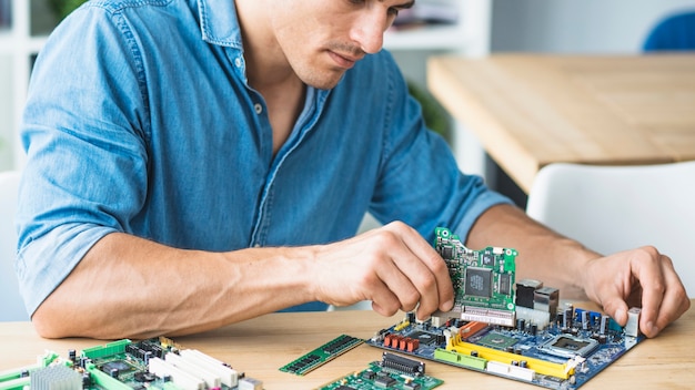 Free photo male technician assembling the hardware equipment's