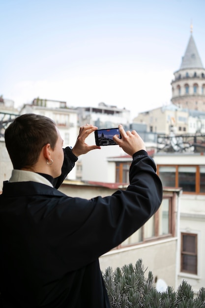 Free photo male tourist taking photos with smartphone during trip