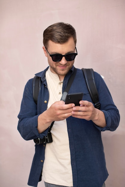 Male traveler with a camera outdoors