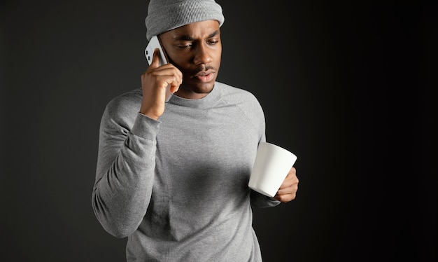 Male wearing cap talking on phone