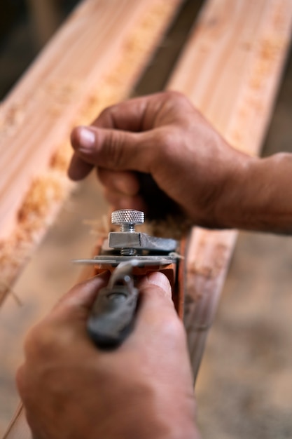 Free photo male wood worker in his shop working with tools and equipment