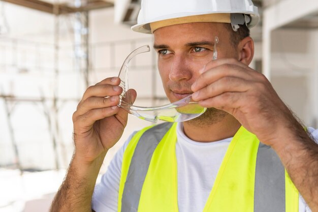 Male worker in construction wearing protection gear