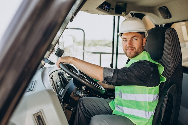 Male worker with bulldozer in sand quarry