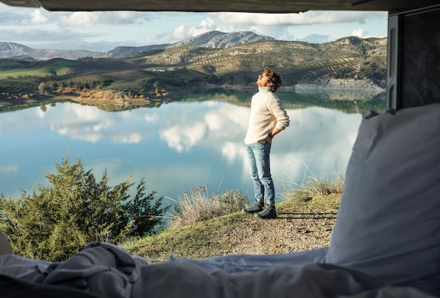 Free Photo man admiring nature while on a road trip