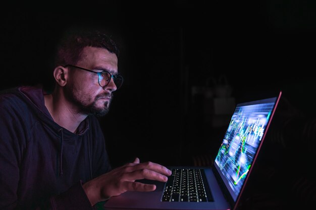 A man analyzing stock market charts financial data on an electronic board