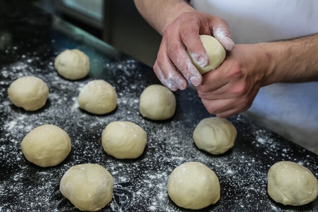 Man are forming dough flour side view