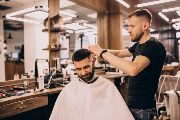 Man at a barbershop salon doing haircut and beard trim