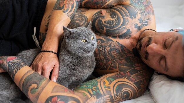 Free Photo man being affectionate with cute cat medium shot