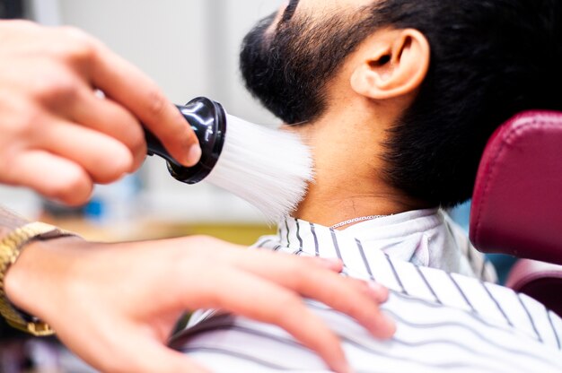 Man being cleaned with a shaving brush