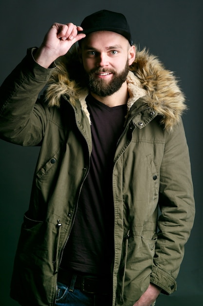 Man in black hat and parka with fur coat 