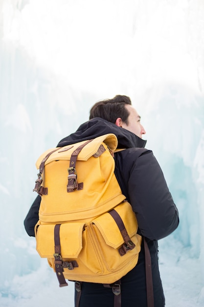 Free Photo man in black jacket and brown backpack