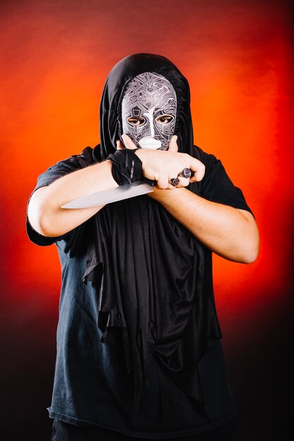 Man in black posing with knife