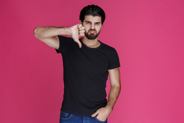 Man in black shirt feeling negative and disappointed about something