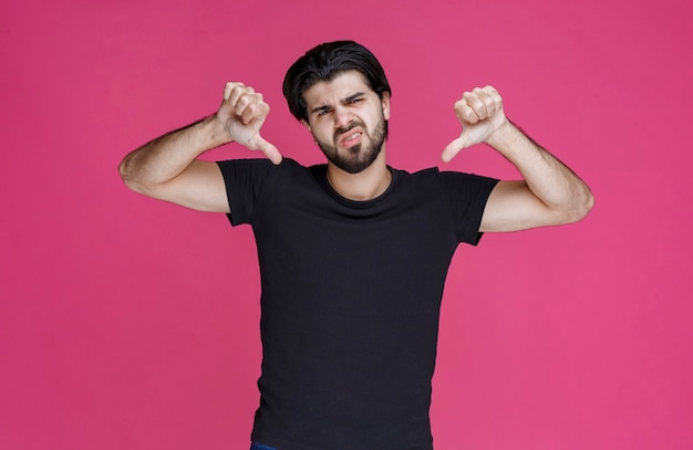 Man in black shirt feeling negative and disappointed about something