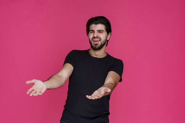 Man in black shirt looks confused, unexperienced and lost