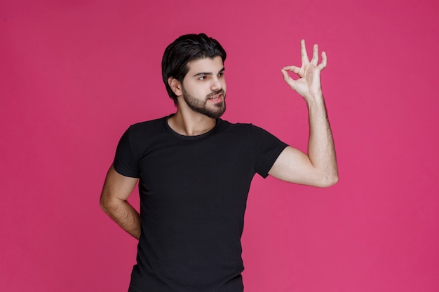 Free Photo man in black shirt shows that he is completely enjoying something