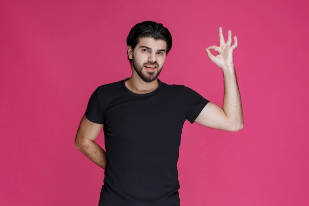 Man in black shirt shows that he is completely enjoying something